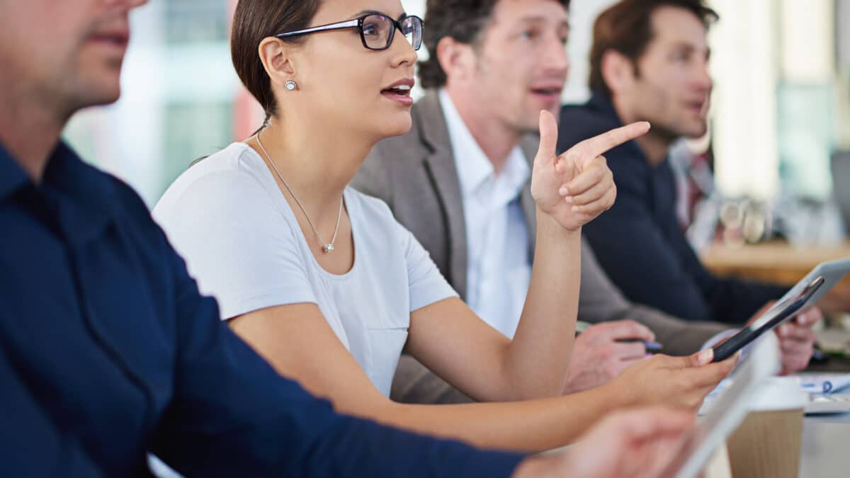 Compliance officer leads a team meeting about ensuring adherence to privacy laws.