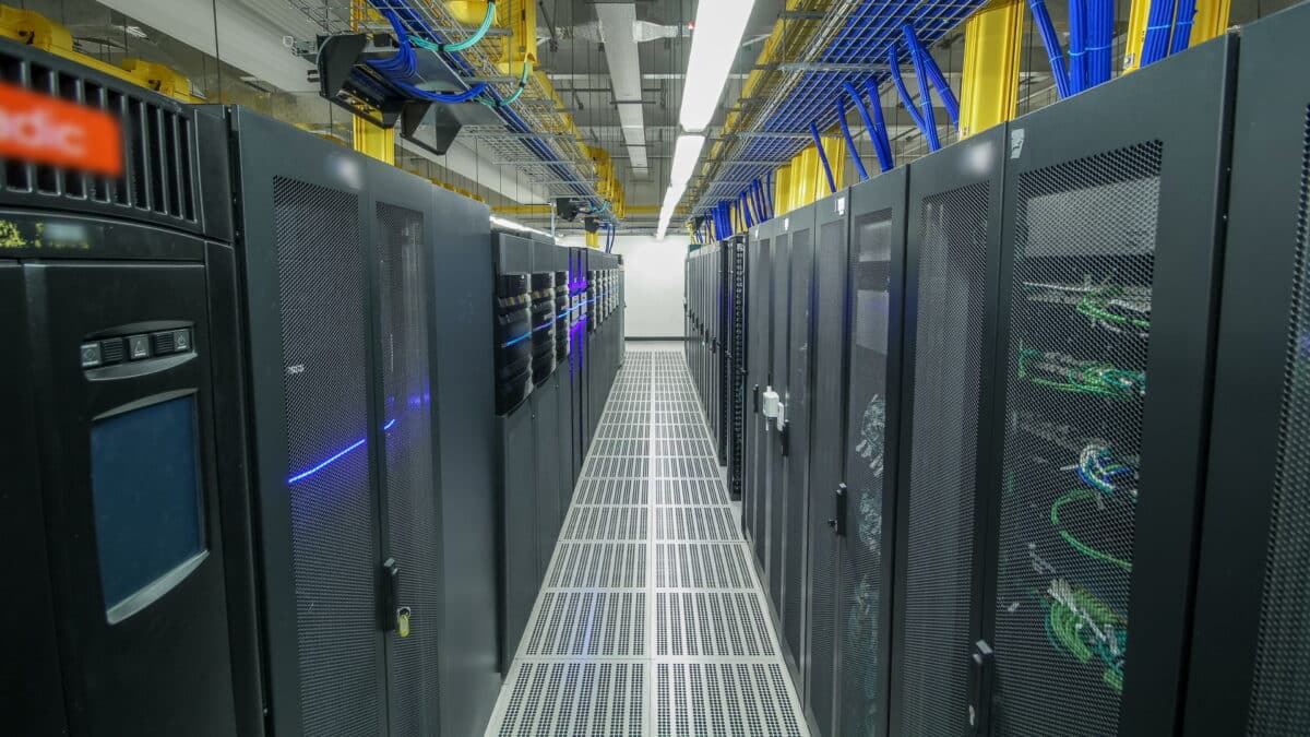 Modern data center with rows of server racks, symbolize the importance of backing up critical data.