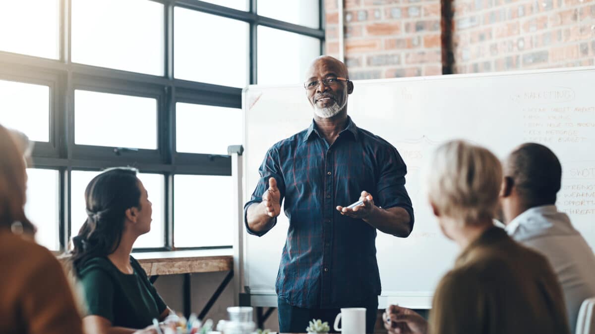 Senior manager leads a cybersecurity training discussion for his small consulting business.