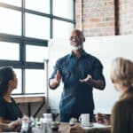 Senior manager leads a cybersecurity training discussion for his small consulting business.