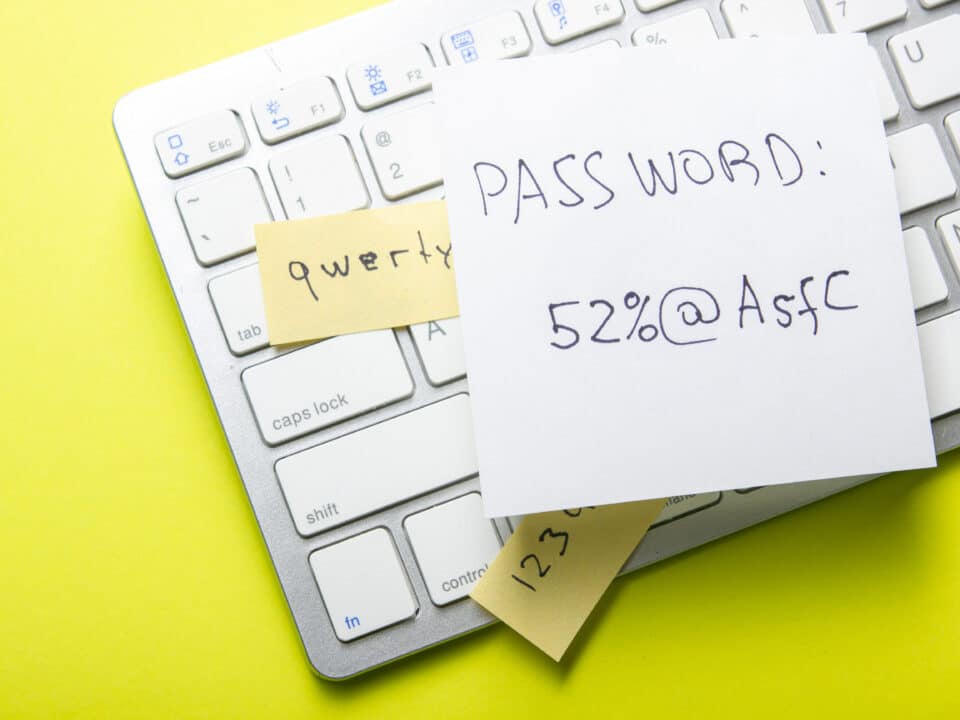 Strong vs. weak password on paper, highlighting Athreon's cybersecurity training for best practices.