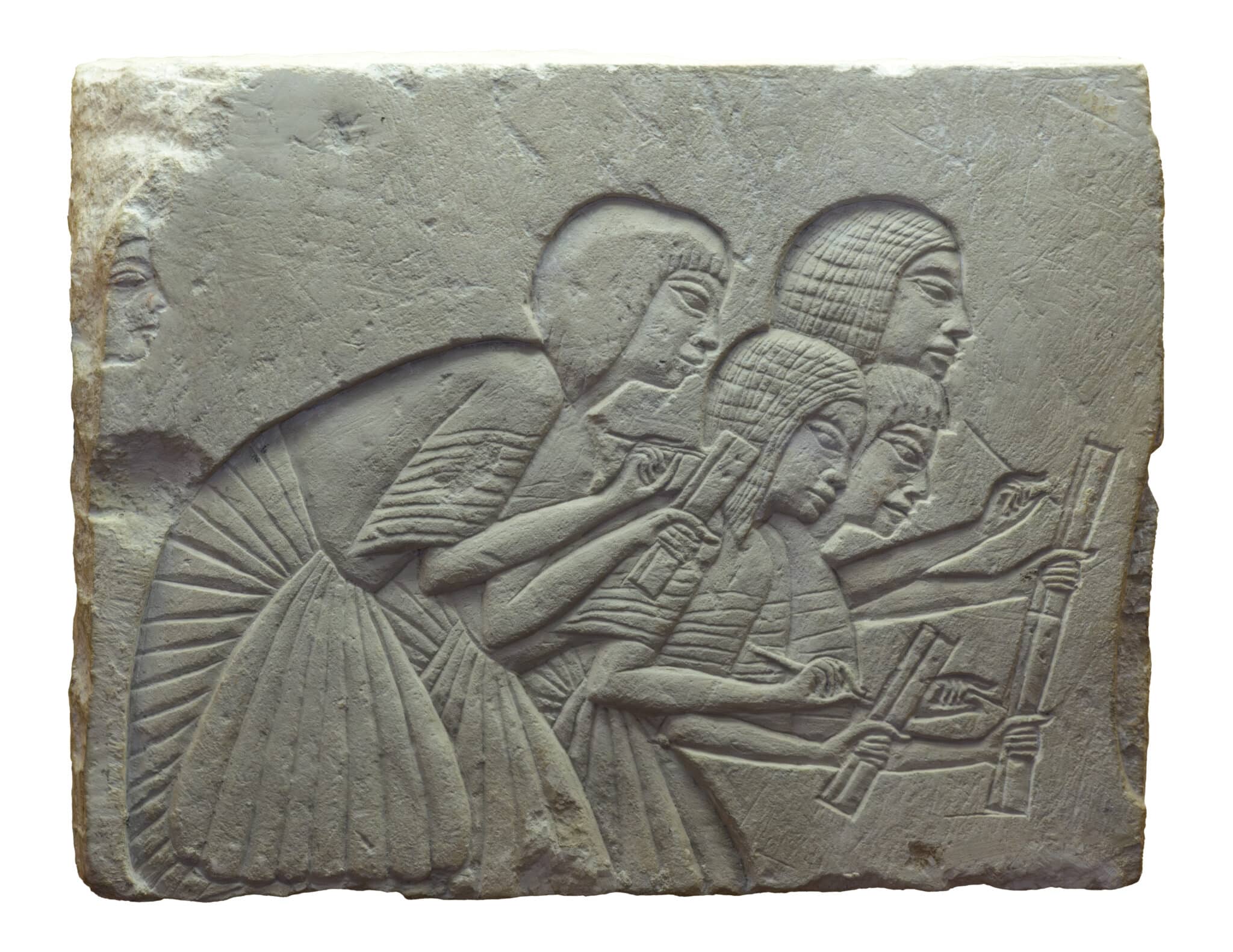 Ancient stone carving depicting scribes with scrolls, illustrating early scribing practices and techniques.