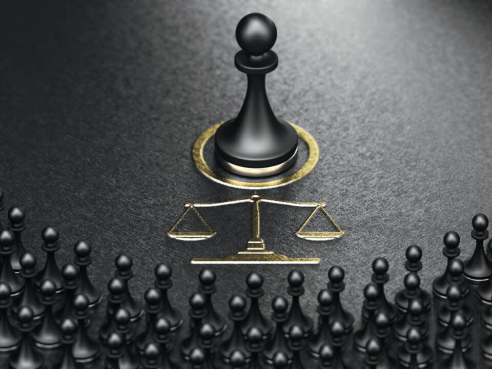 Black chess pawn & scales of justice, surrounded by pawns, symbolize legal scrutiny post-data breach