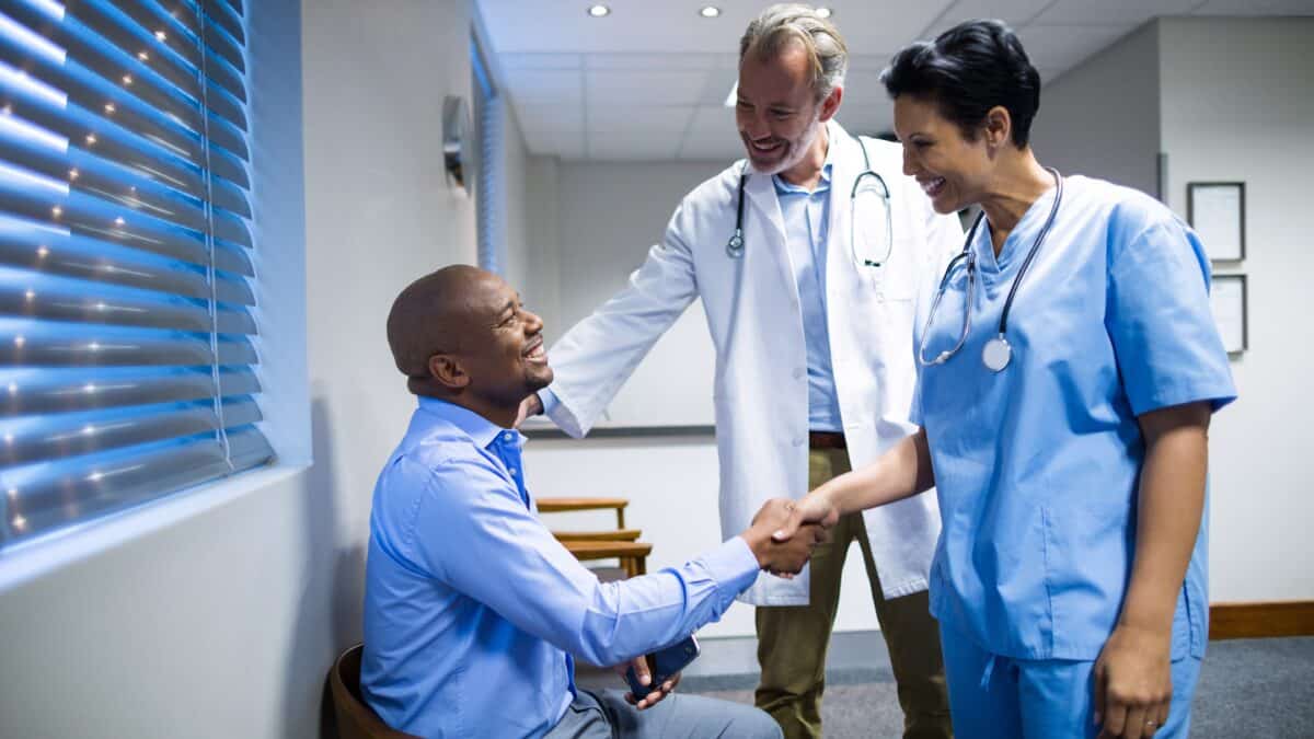 Physician and nurse greeting a patient, highlighting AxiScribe AI's real-time transcription benefits