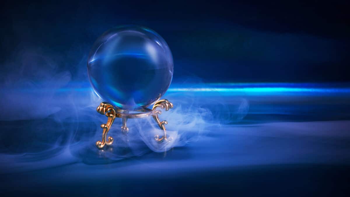 A glowing crystal ball, surrounded by blue mist, symbolizes near magical capabilities of AI scribes.