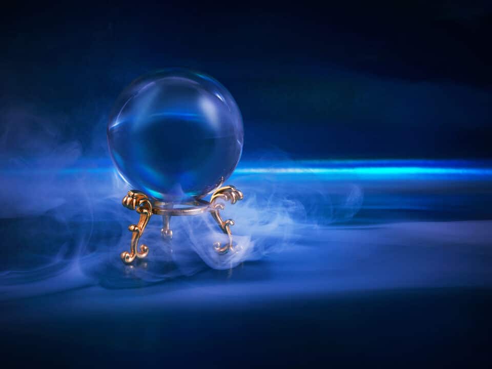 A glowing crystal ball, surrounded by blue mist, symbolizes near magical capabilities of AI scribes.