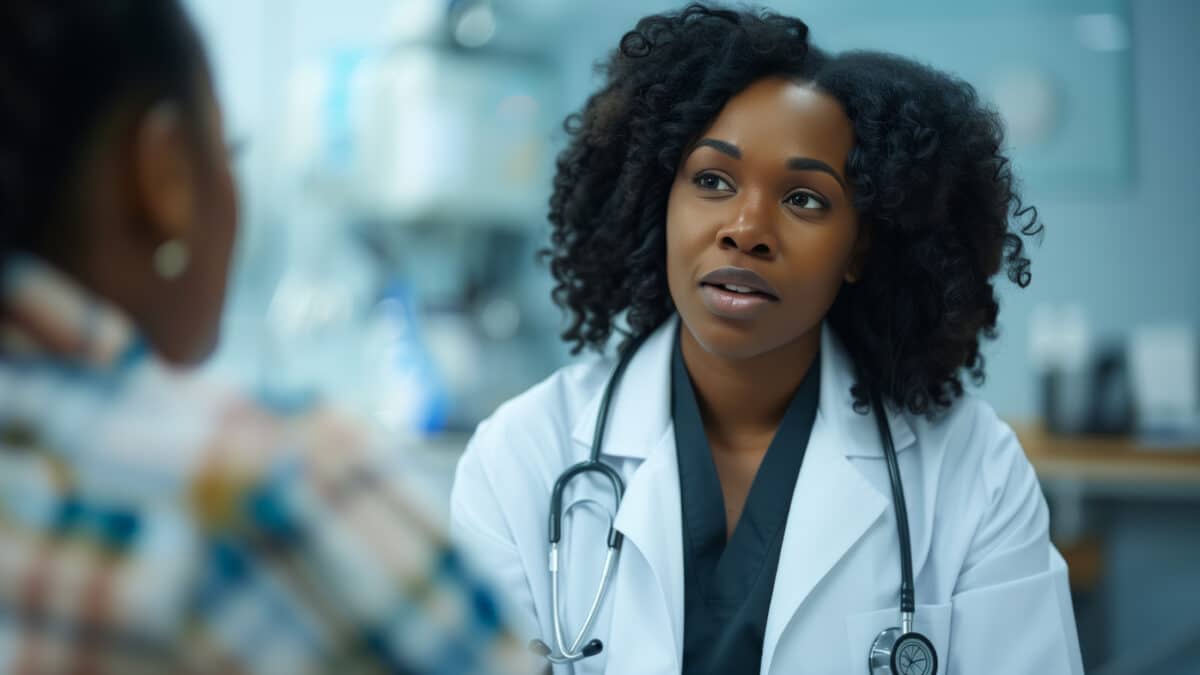 Doctor attentively listening to a patient, highlighting how AI scribes enhance patient care.