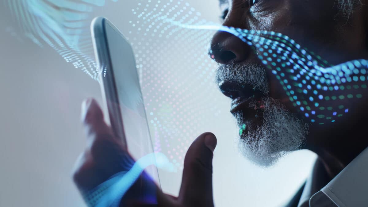 Elderly man using speech recognition on smartphone with digital waveforms in the background.