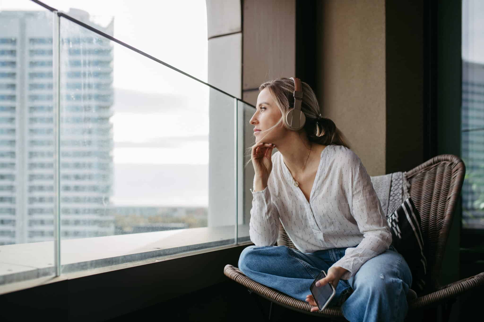 Off-duty doctor sits on a balcony, representing work-life balance enabled by AI medical scribes.