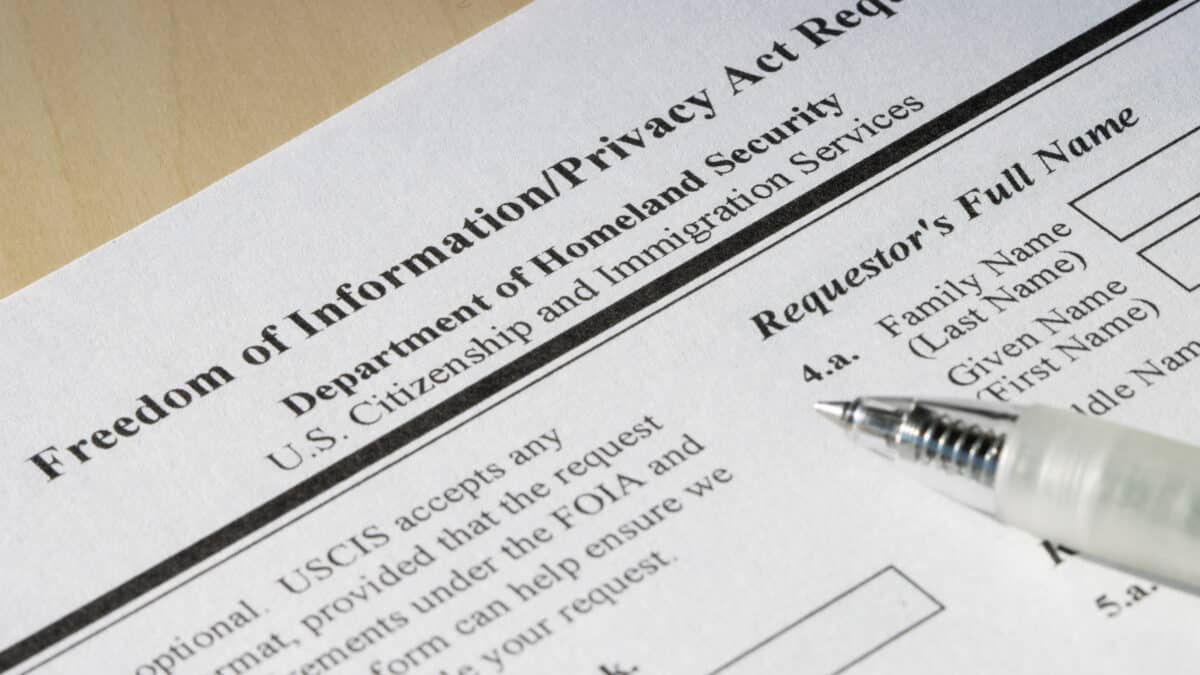 FOIA request form close-up with pen, highlighting the role of transcription in government transparency.